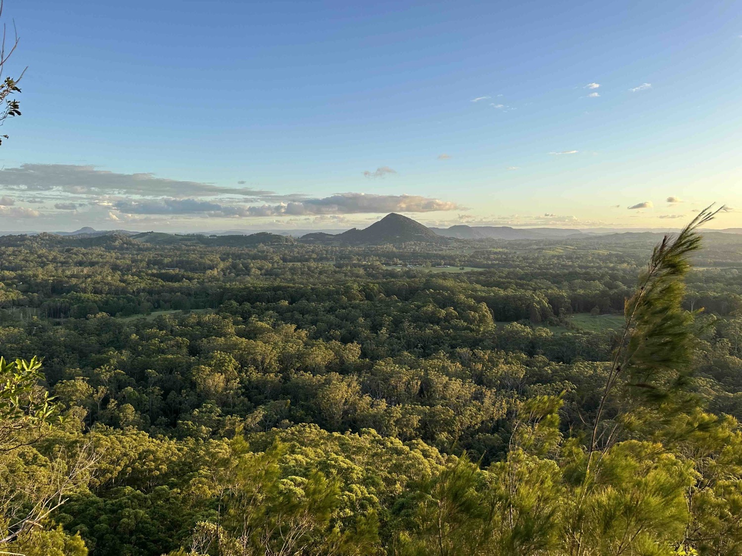 Noosa hinterland at golden hour with a distant volcanic peak